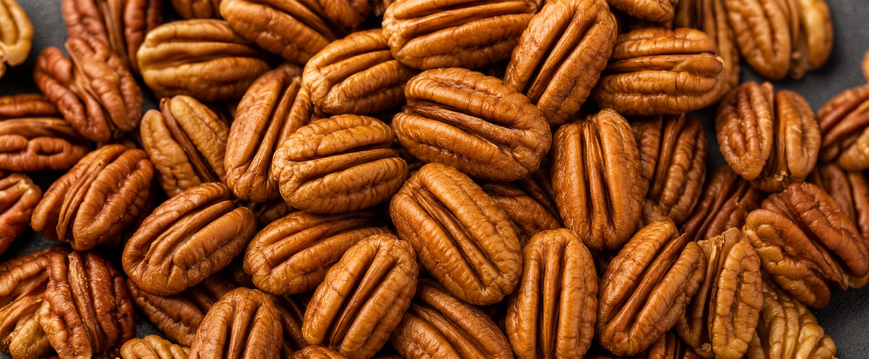 a close up of unblemished shelled pecan halves